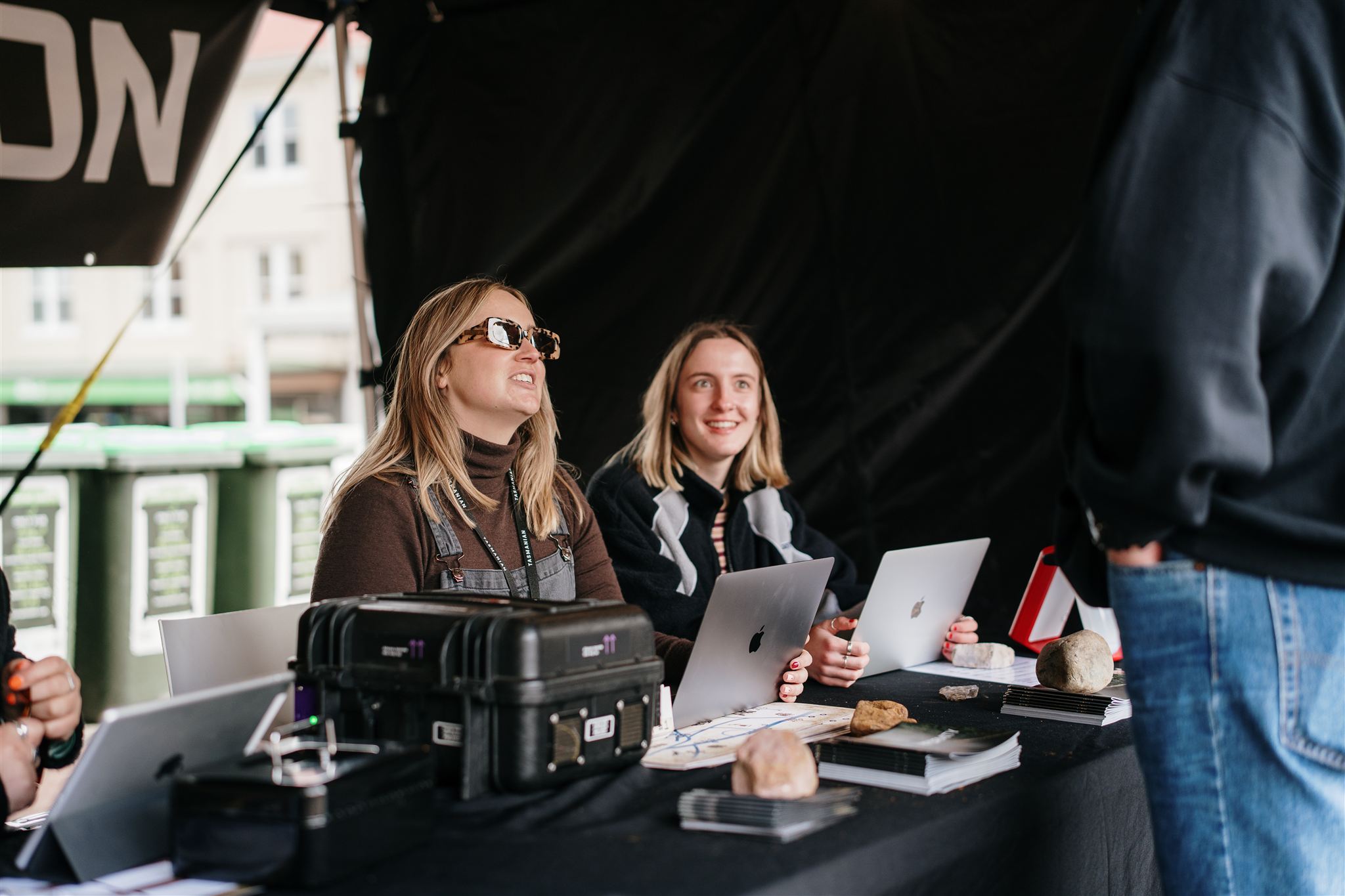 Friendly staff checking in guests at the box office with event internet box rented from PopUp WiFi to stay connected.