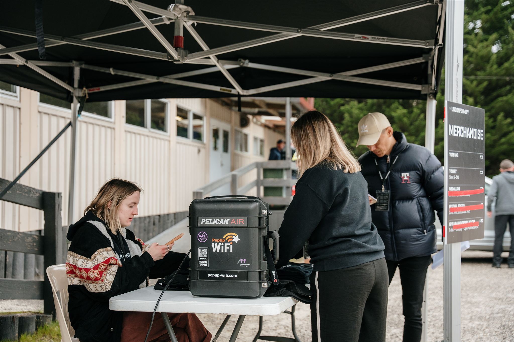 Production staff checking in attendees at festival using PopUp WiFi bonded internet solution for rent in Australia.